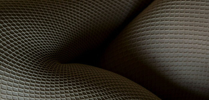 Up close image of fishnet tights on womans legs